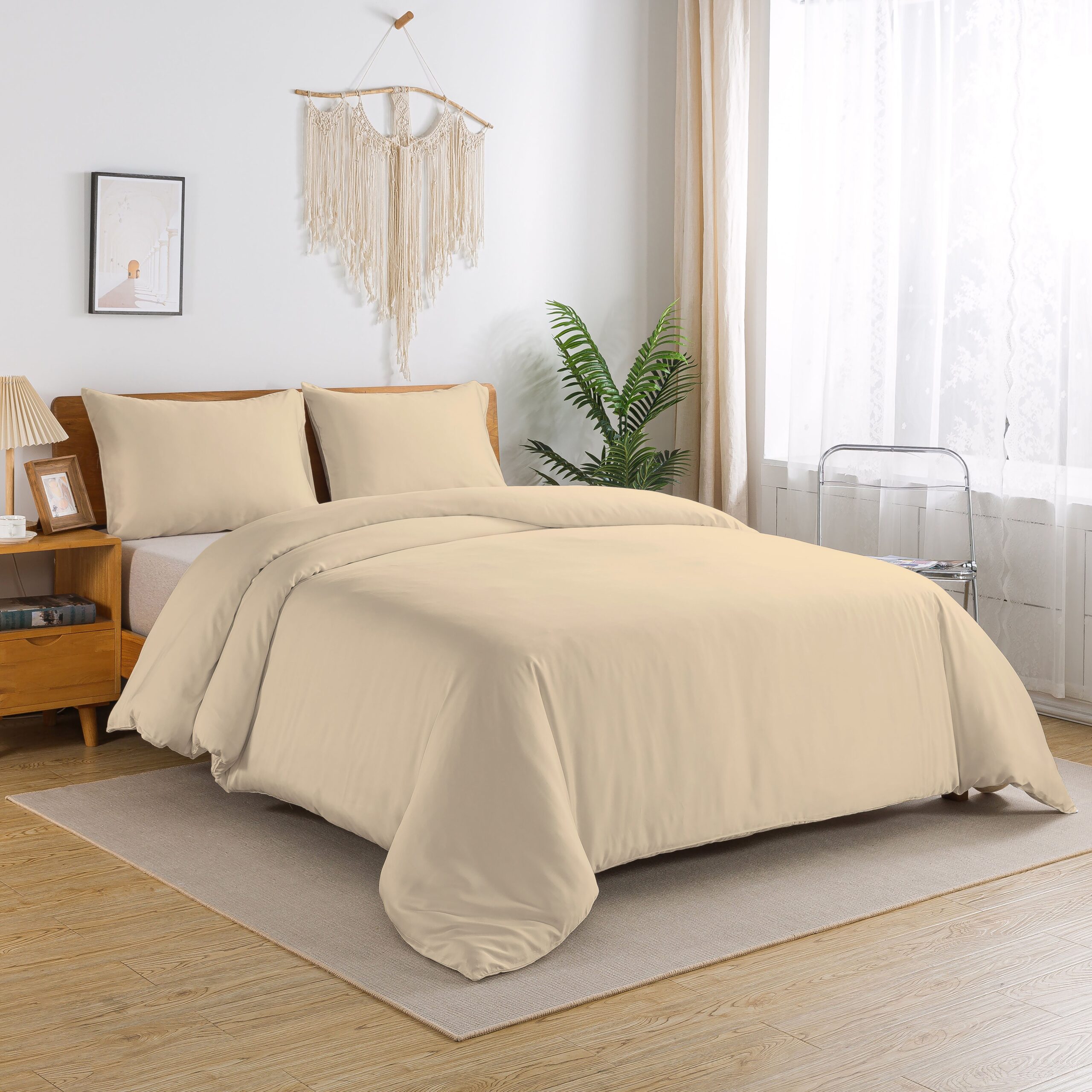 Stylish minimalist bedroom featuring beige bedding, modern furniture, and soft natural light.